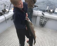 Big smiles for this kid after reeling in a Lake Trout!